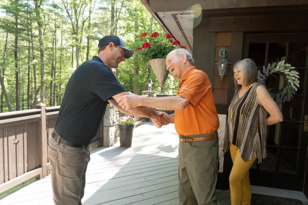 A Blue Planet technician greeting homeowners at their mountain home