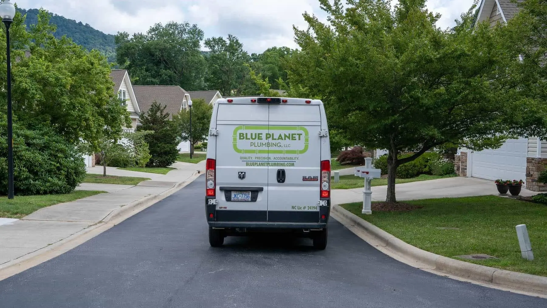 A Blue Planet Plumbing van in an Asheville neighborhood